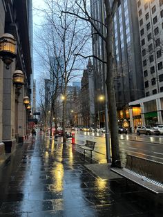 an empty city street at night with rain on the ground