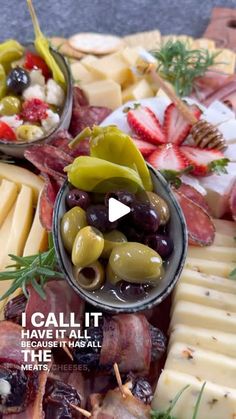 an assortment of cheeses, olives and meats on a platter