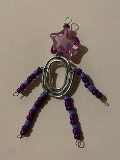 a purple beaded necklace with a star hanging from it