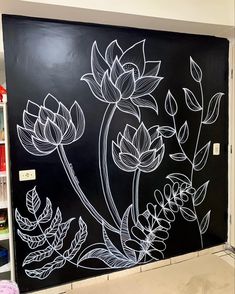 a blackboard with white flowers painted on it