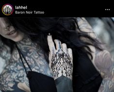 a woman with tattoos on her arms and hands