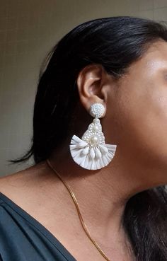 Bohemian handmade white raffia and beaded embellished bridal earrings. These hand embroidered earring made of white raffia,faux pearl, acrylic,glass,faux pearls metallic wire, zari and other material. Earrings are light in weight and an ideal bridal jewelry. Carnation jewellery are purely handmade & handcrafted in India. Since our product is purely handmade in nature hence a slight imperfection may be there but it is almost negligible. The colors and may slightly vary from the images shown but I Bohemian Embroidered Jewelry For Wedding, White Tassel Jewelry For Festival, Festival White Jewelry With Tassels, Festival White Tassel Jewelry, Elegant Embroidered Jewelry For Festival, Elegant Embroidered Festival Jewelry, White Tassel Chandelier Drop Earrings, Traditional White Beaded Earrings For Celebration, White Chandelier Earrings For Festival