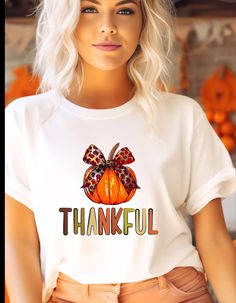 A fall themed T-shirt featuring a beautiful orange pumpkin with a bow and colorful 'thankful' lettering. Perfect for the autumn season, Thanksgiving, and harvest celebrations. Provides a cozy and festive vibe, ideal for anyone looking to add a touch of gratitude to their wardrobe.Great for a Fall lovers! Product features - Made from 100% ring-spun cotton for a lightweight and comfortable feel - Classic fit with crew neckline suitable for any occasion - Ethically grown and harvested US cotton for sustainability - Variety of fabric blends available for different color options - Tear-away label for added comfort and customization Care instructions - Do not dryclean - Machine wash: warm (max 40C or 105F) - Do not bleach - Tumble dry: low heat - Iron, steam or dry: low heat Thankful Pumpkin, Harvest Celebration, Fall Lovers, Patch Top, Orange Pumpkin, Fall Tee, Thanksgiving Outfit, Autumn Season, Pumpkin Orange