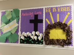 a bulletin board with paper flowers and a cross