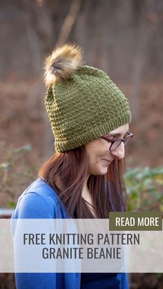 a woman wearing a green knitted hat with a pom - pom on it