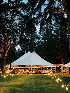 a large tent is lit up with candles