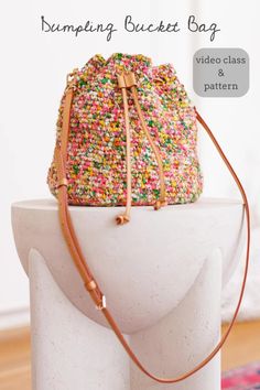 a white bag with colorful sprinkles on it sitting on top of a pedestal