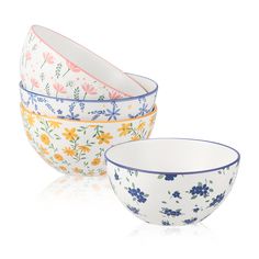 three bowls with flowers painted on them