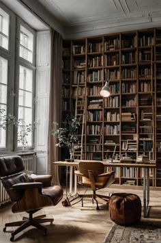 a chair and desk in front of a bookshelf filled with lots of books