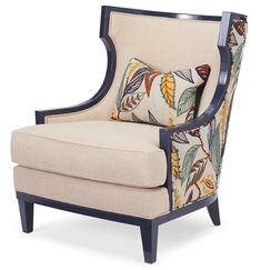 an upholstered chair with colorful leaves on the armrests and back, against a white background