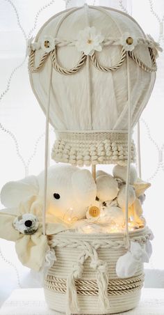 stuffed animals in a white basket with lights