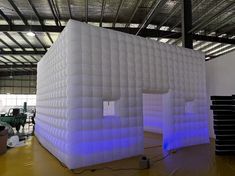 an inflatable building with blue lights inside