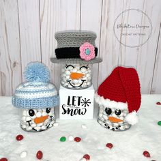 three snowman jars with hats and candy in them