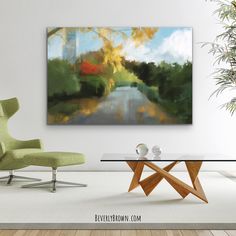 a painting on the wall above a glass table in a room with chairs and a green chair