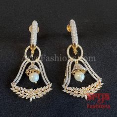 Zara Victorian Golden CZ Party Earrings Party/Trendy/Silver Cubic Zirconia Earrings/Ethnic earrings/American Diamond Earrings 1-Made in Brass 2-Length: 2.25 Inches 3-Available in Victorian and Golden finish 4- Made with very high quality CZ Stones 5- Lightweight Jewelry 6- Suitable for any traditional or contemporary occasion 7-Very Elegant and stylish, suitable for any attire. 8- Comes with push back closure Elegant Festive Hoop Earrings For Party, White Cubic Zirconia Party Earrings, White Cubic Zirconia Hoop Earrings For Party, White Elegant Earrings For Party, Party Pearl Earrings With Cubic Zirconia, White Elegant Party Earrings, Elegant White Party Earrings, Party Silver Chandelier Earrings With American Diamond, Festive Party Pearl Earrings