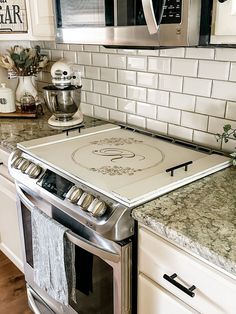 a stove top oven sitting inside of a kitchen