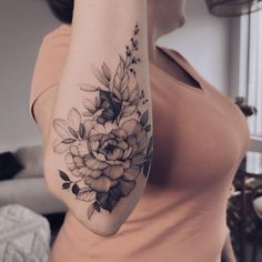 a woman with a flower tattoo on her arm