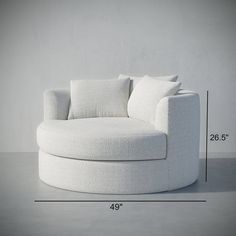 a large white chair with pillows on it's back and measurements for the seat