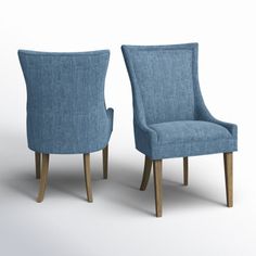 two blue chairs sitting next to each other on a white surface with one chair facing the other