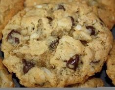 two cookies on a white plate with chocolate chips