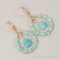 two pairs of earrings with blue beads on them