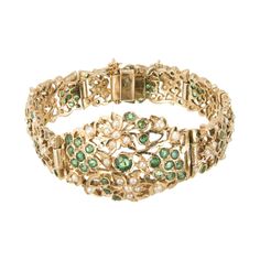 Emerald and pearl hinged link bracelet. 104 round emeralds in an open work 14k yellow gold bracelet with 65 accent seed pearls. 104 round green emeralds, approx. 2.80cts 65 crème seed pearls 14k yellow gold Stamped: 14k 37.9 grams Bracelet: 7 Inches Width: 2.5-13mm Thickness/Depth: 3mm Victorian Green Bracelet Jewelry, Yellow Gold Emerald Bracelets For Wedding, Elegant Green Gold Bracelet For Wedding, Victorian Art Deco, Antique Wedding Bands, Diamond Sapphire Engagement Ring, Cultured Pearl Bracelet, Antique Engagement Rings Vintage, Retro Bracelet