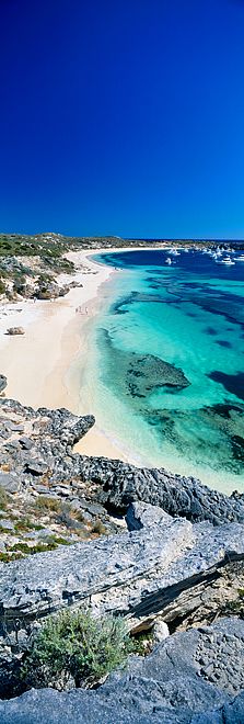 the beach is surrounded by rocks and clear water