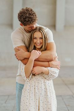 a man and woman hugging each other in front of the lincoln memorial, washington dc