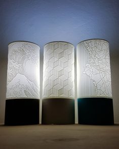 three lamps sitting next to each other on a table