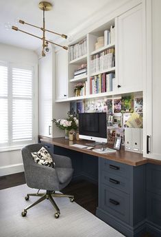 a home office with built in bookshelves and desk