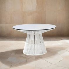 a white table sitting on top of a tiled floor next to a wall and window