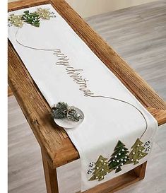 a white table runner with christmas trees on it