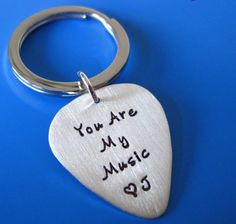 a guitar pick keychain with the words you are my music on it