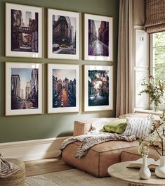 a living room with green walls and pictures on the wall above the couch in front of it