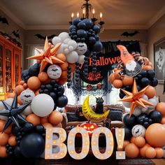 a halloween balloon arch with balloons and decorations