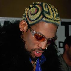 a man wearing sunglasses and a wig with dreadlocks on it's head