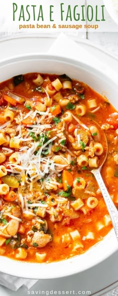 pasta faggioli soup in a white bowl with a spoon on the side