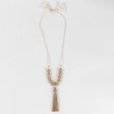 The Aaloka Beaded Tassel Necklace is your new go-to accessory! Handcrafted in India, this chunky, beaded necklace features jute beads and a tassel. Its natural finish is perfect for any season. Jute is a sustainable material made from the cellulose fibers of jute plants, a fast-growing, high-yield crop that requires little water. It’s durable, biodegradable and locally available. The adjustable knot closure lets the wearer choose between different lengths and styles. Beige Tassel Jewelry For Beach, Adjustable Natural Wooden Beaded Necklaces, Adjustable Beige Beaded Necklace With Wooden Beads, Adjustable Beige Beaded Necklaces With Wooden Beads, Adjustable Beige Beaded Bohemian Necklaces, Adjustable Beige Beaded Bohemian Necklace, Adjustable Beige Bohemian Beaded Necklaces, Adjustable Beige Wooden Beaded Necklaces, Beaded Tassel Necklace With Round Beads For Beach