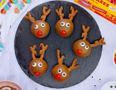 four chocolate reindeer candies are on a plate with candy eyes and nose rings, ready to be eaten