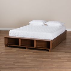 a bed sitting on top of a hard wood floor