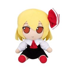 a stuffed doll with red eyes and a black skirt sitting on the ground next to a white background