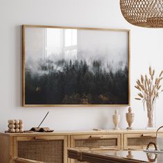 a painting hanging on the wall above a dining room table