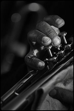 black and white photograph of a person's hand holding a bicycle chain