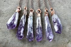 "This listing is for one raw Bahia amethyst crystal necklace featuring one elestial amethyst crystal wand set in thick natural copper and dangling from copper chain. Sometimes called \"Dragon's Teeth\", these amethyst wands are mined in Bahia, Brazil and are gorgeously unusual with deep purple colors and white crystalline elestial structures cascading down the sides. Each is a natural \"euhedral\" meaning they are not cut from larger clusters, but form on their own one at a time. Wear these uniq Purple Raw Stone Crystal Pendant Necklace, Purple Amethyst Necklace With Raw Stone, Bohemian Amethyst Crystal Necklace With Raw Stone, Spiritual Purple Crystal Necklace With Raw Stone, Purple Amethyst Crystal Necklace In Mystical Style, Mystical Purple Amethyst Crystal Necklace, Purple Electroformed Amethyst Jewelry, Purple Amethyst Jewelry With Raw Stones, Amethyst Wand