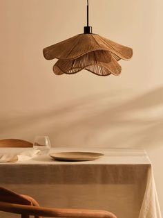 a dining room table with a plate and an umbrella hanging from it's ceiling