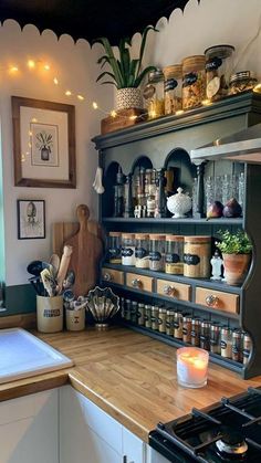 a kitchen filled with lots of pots and pans on top of a wooden counter