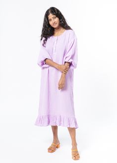 The Bathtan is our take on the classic caftan, a house dress made for wearing after the bath and beyond. The pillowy soft 100% cotton gauze feels like stepping into a delicate purple cloud, while the elasticized sleeves, bottom ruffle and functional collar buttons add the perfect touch of tailoring. Product Details: 100% cotton S/M fits up to US dress size 10. Measurements are 47" length, 23" shoulder (across back), 23" waist (across back), 19" sleeve Sizing transparency: As this is a new produc Cotton Dresses For Relaxation, Relaxing Cotton Dresses, Spring Daywear Cotton Gauze Maxi Dress, Spring Cotton Gauze Maxi Dress For Daywear, Spring Cotton Gauze Dresses For Loungewear, Spring Cotton Gauze Loungewear Dresses, Flowy Cotton Dress For Loungewear, Relaxed Fit Cotton Gauze Dress, Cotton Beach Nightgown With Ruffles