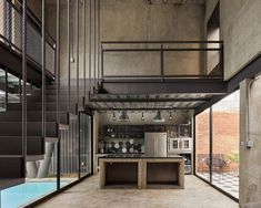 an open kitchen and living room with stairs leading up to the second floor