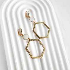 This season, glow for gold in this statement pair with trendy geometric shapes. GEMSTONE: Moonstone MATERIAL: Brass CLOSURE: Gold plated leverback LENGTH: 2.75" long Modern Gold Octagon Earrings, Modern Gold Hexagon Earrings, Minimalist Gold Octagon Earrings, Gold Geometric, Geometric Earrings, Gemstone Earrings, Geometric Shapes, Statement Earrings, Moonstone