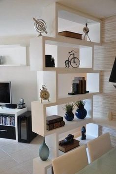 a living room filled with furniture and a flat screen tv on top of a wooden shelf